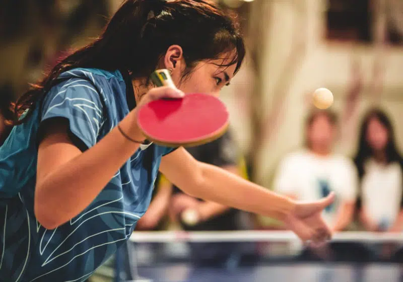 Girl playing table tennis or ping pong, a sport that is popular in Asia.